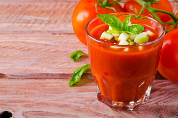 Tomato gazpacho in a glass with basil ang zucchini