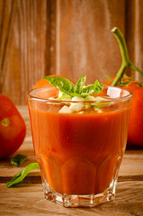 Tomato gazpacho in a glass with basil ang zucchini
