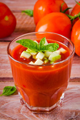 Tomato gazpacho in a glass with basil ang zucchini