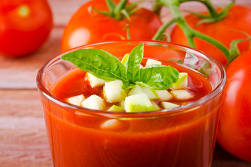 Tomato gazpacho in a glass with basil ang zucchini