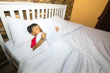 Boy relaxing on a soft bed

