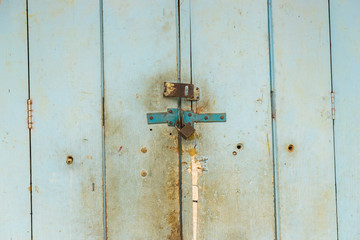 Old padlock on a wooden door