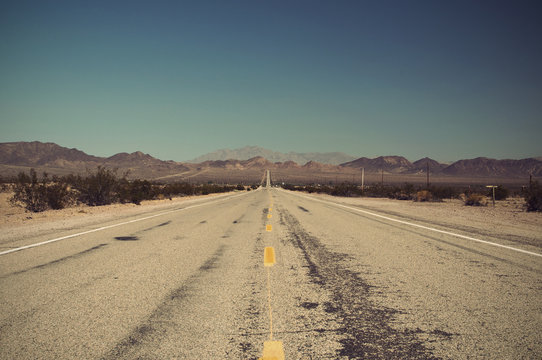 long lonely old asphalt road Route 66 in Arizona and blue sky, USA, Vintage filtered style