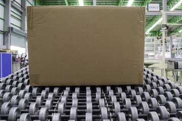 Cardboard boxes on conveyor belt in distribution warehouse