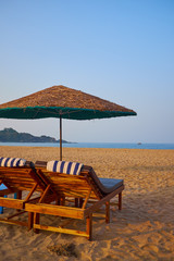 empty beach chairs on a tropical beach