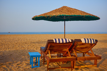 empty beach chairs on a tropical beach