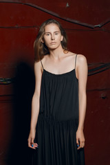 fashion model in long designers black dress in night show