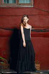 fashion model in long designers black dress in night show