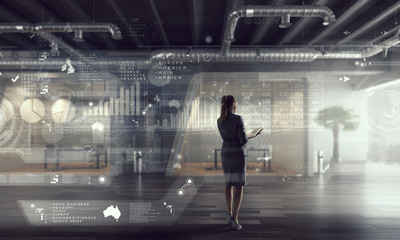 Fototapeta premium Businesswoman in modern office interior . Mixed media