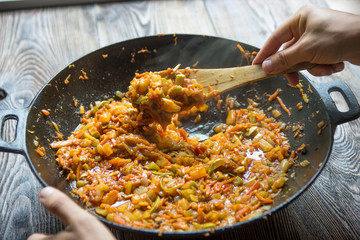 Cooking chongqing vegetables in wok at home