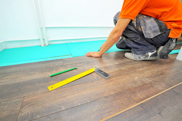 Carpenter doing laminate floor work