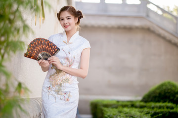 Asian Chinese woman in Traditional Chinese .hold .Fanning paper