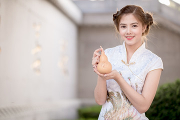 The Asian Chinese woman in Traditional Chinese hold calabash