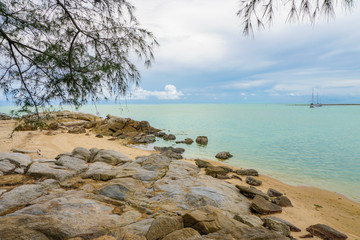 Cloudy seascape with rocky shore in Thailand