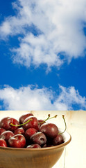 image of cherry in a bow on sky background closeup