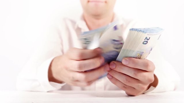 Man's hands counting the bundle of euro 20 banknotes close up video
