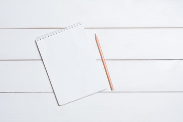 Blank empty notepad with pencil on table