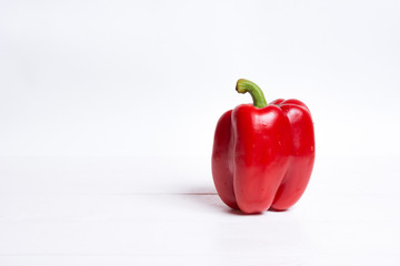 Red bell pepper on white wooden table
