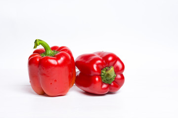 Red bell peppers on white wooden table