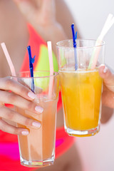 Girlfriends with cocktails at the poolside bar. Summer time