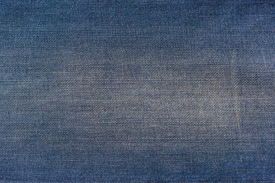 Closeup denim jeans texture. Stitched textured blue denim jeans