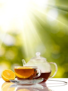 image of cups with tea and  lemon on sunlight background