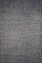 Closeup denim jeans texture. Stitched textured black denim jeans