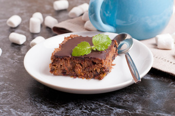 chocolate cake slice, decorated mint and marshmallows