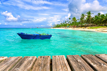 Naklejka na ściany i meble Fishing boat at the sea coast of the Dominican Republic. Blue fishing boat.
