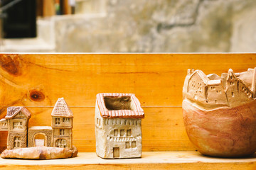 Small clay house model  in woodshelf interior decorate