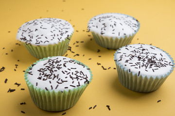 Vanilla cup cake with white icing and candies on top
