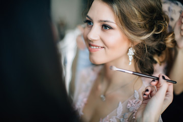 bride doing make-up and she was very pleased with a smile on his face