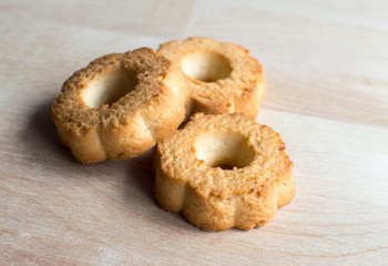 Three cookies on wooden desk. Closeup bright and nature light