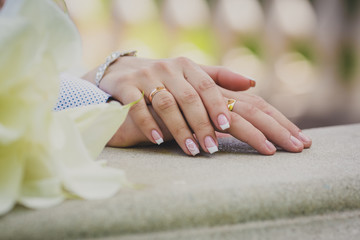 Hands of the newlyweds with rings