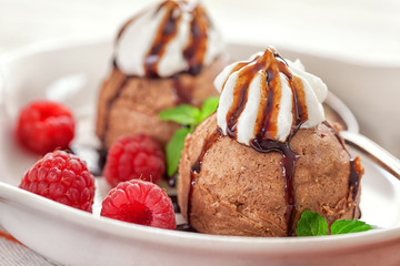 Fototapeta na wymiar Chocolate ice cream with raspberry 