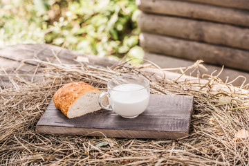 bread and milk cup on wooden board