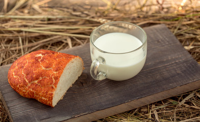 Fototapeta na wymiar bread and milk cup on wooden board