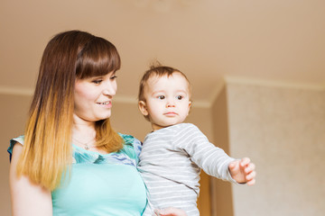 Portrait of happy mother and baby at home