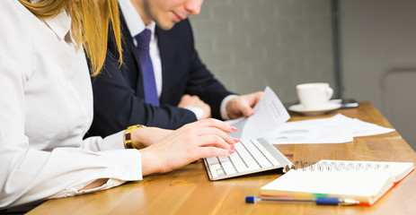 Business people discussing the charts and graphs showing the results of their successful teamwork