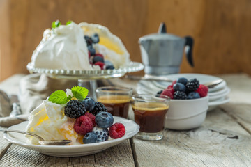 Pavlova with berries and coffee