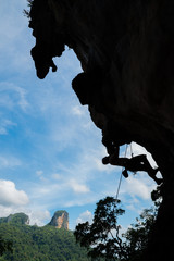 Silhouette of a climber on a cliff during day time