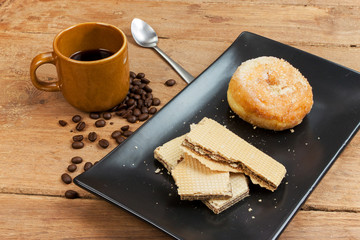 coffee and wafer stick and donuts sugar