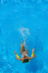 Fototapeta na wymiar Beautiful young woman in bikini Relaxing in a pool