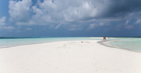 People walking on white sandy beach, Kuredu, Maldives