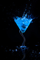 blue cocktail with splash and ice vapor