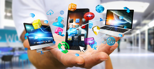 Businessman holding tech devices and icons applications © sdecoret