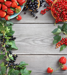 Harvest of  berries  on old wooden table. Copy space for your text. Top view, high resolution product.