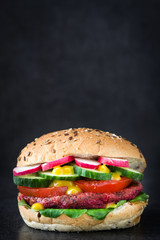 Veggie beet burger on black slate background

