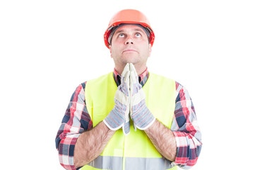 Construction engineer holding hands closed and praying