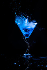 blue cocktail with splash and ice vapor